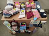 many pairs of socks on a table in a room