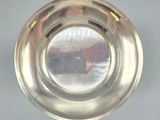 a silver plate with a circular design on it