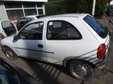 a white car parked in a parking lot next to other cars