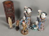 five figurines of asian women and a vase on a table