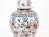 an image of a white and blue vase with a lid
