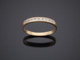a yellow gold wedding band with princess cut diamonds