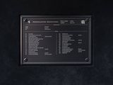 a black sign on a black wall that has information on it