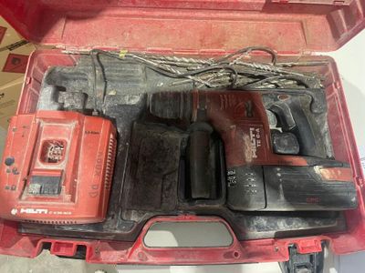 a red tool box with tools in it on a table