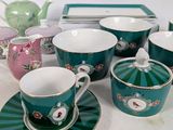a lot of tea cups and saucers sitting on a table