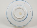 underside view of a blue and white plate with a circular design