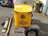 a yellow machine that is sitting on a trailer