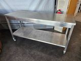 a stainless steel table with a shelf underneath it