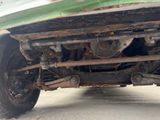 a close up view of the rear end of a green truck