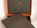 an orange and black box containing a wallet and a wallet case