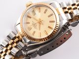 an image of a gold and silver wrist watch with roman numerals
