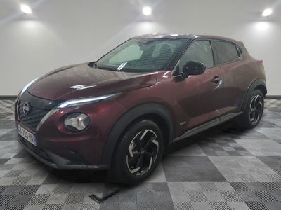 the red nissan kicks up to a checkered floor in a garage