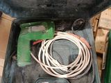 a person holding a tool in a green case