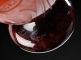 a close up of a spoon with a liquid inside of it