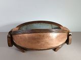 an image of a copper bowl with a glass top on a table