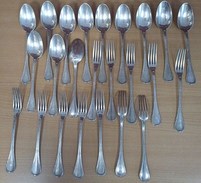 a lot of silver spoons and forks on the table