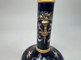 a blue vase with a gold decoration on it