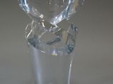 a glass vase with a broken glass inside of it on a table