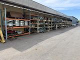 a large warehouse with a lot of metal pots and pans on the shelves