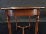 an image of a small wooden table on a black surface
