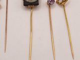 three gold - plated hair pins with a picture of a woman and a man