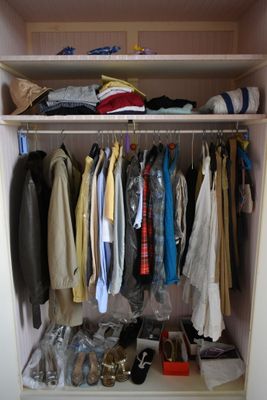 a closet with a lot of clothes and shoes on it