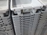 many plastic containers stacked on a pallet in a store