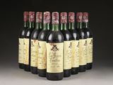six bottles of wine are lined up in a row on a table