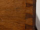 close up of a wooden drawer with a drawer pull open