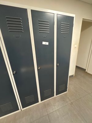 three lockers in the hallway of a building