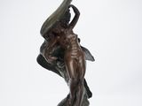 bronze statue of a woman holding a large fish on a pedestal