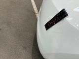 a sticker on the hood of a white car