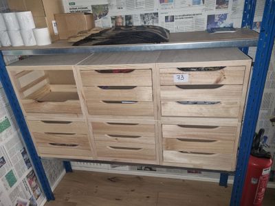 a wooden cabinet with drawers and shelves in a room