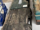 a black case sitting on top of a table next to a stack of boxes