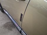 a close up of a car door handle with a sticker on it