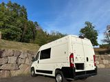 a white van with bullet holes on it parked in a parking lot