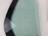 a glass window with a black frame on the side of a white wall