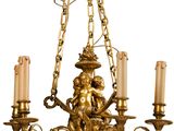 un lustre en or auquel sont suspendues des bougies