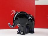 a black elephant figurine on a table next to a red box
