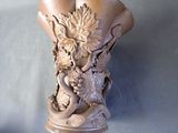 a sculpture of a vase with a dragon on it