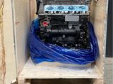 a small engine in a wooden box on a pallet