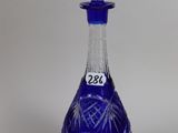 an image of a blue glass decanter on a white background