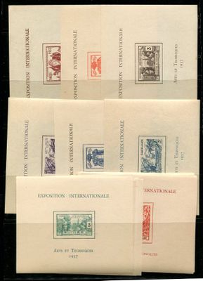 several envelopes with stamps on them sitting on top of each other