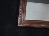a mirror hanging on the wall in a bathroom