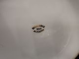 an image of a white plate with a brown inscription on it