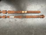 two old wooden knives are sitting on a metal surface