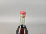 a bottle of soda with a red cap on it