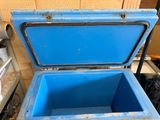 a blue cooler sitting on the floor in a room