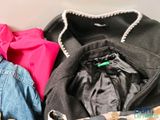 a pile of clothes that is sitting in a suitcase