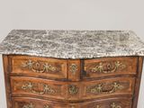 a marble top chest of drawers with a marble top